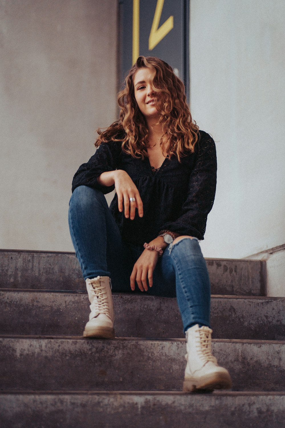 a woman sitting on the steps of a building