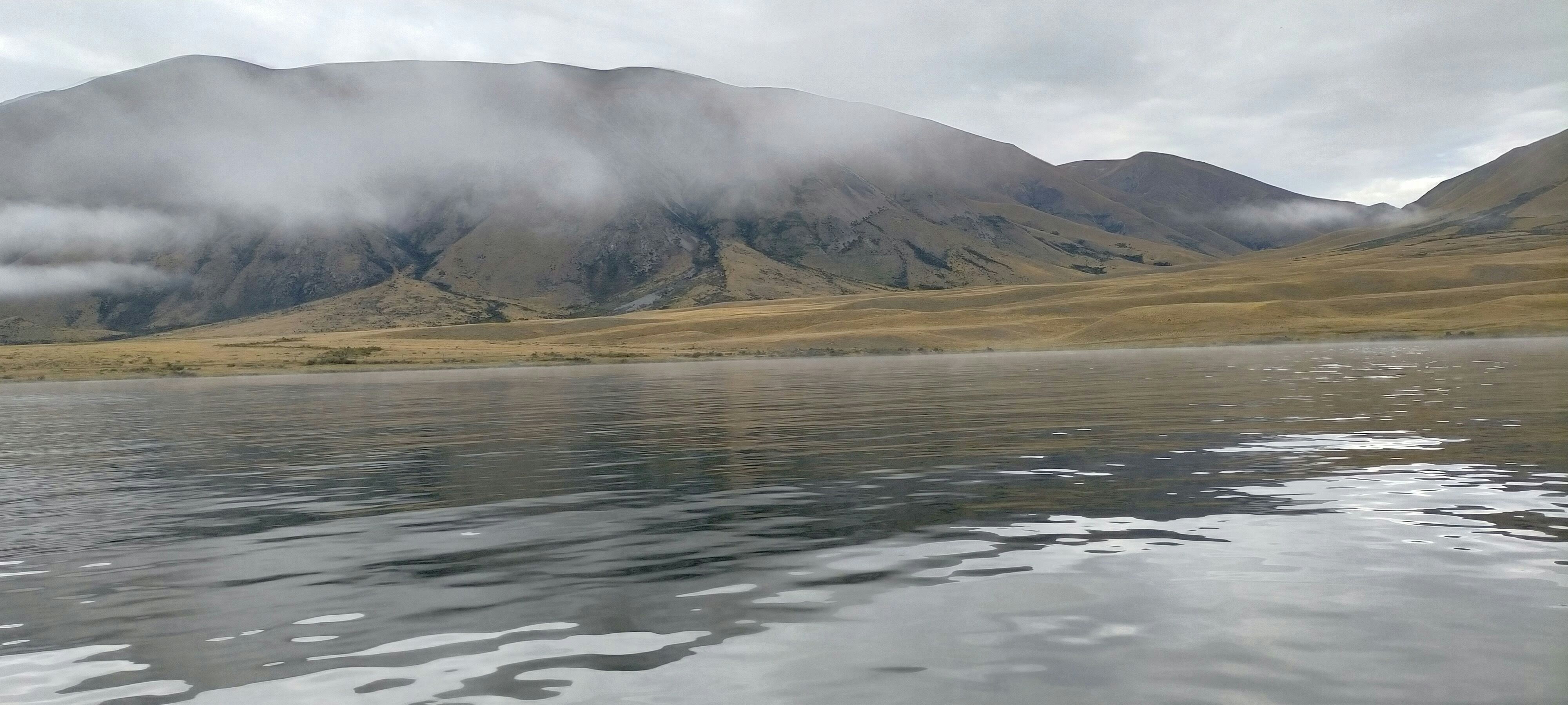 a body of water with a mountain in the background