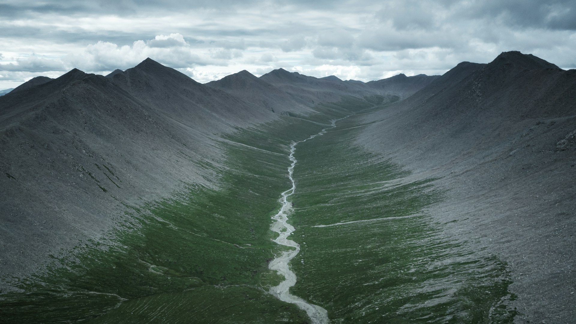 a view of a mountain range with a river running through it