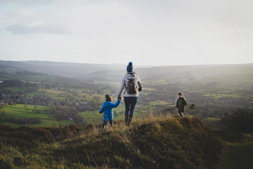 a person with a child walking up a hill