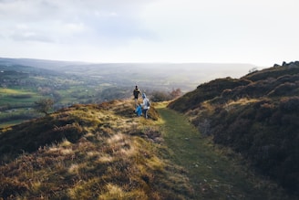 a couple of people that are standing on a hill