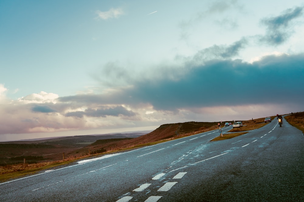 a long empty road with a sky background