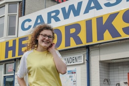 Friendly staff member smiling outside the 24 Hours Carpet Cleaning Hempstead office.