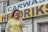 A happy customer standing outside the dry cleaners in Orlando.