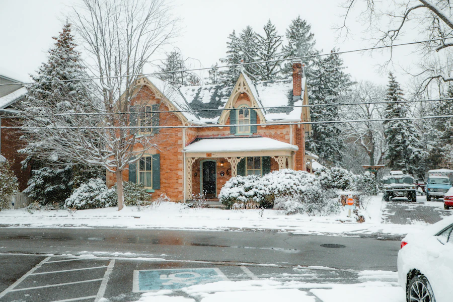 A brick house and driveway covered in fresh snow