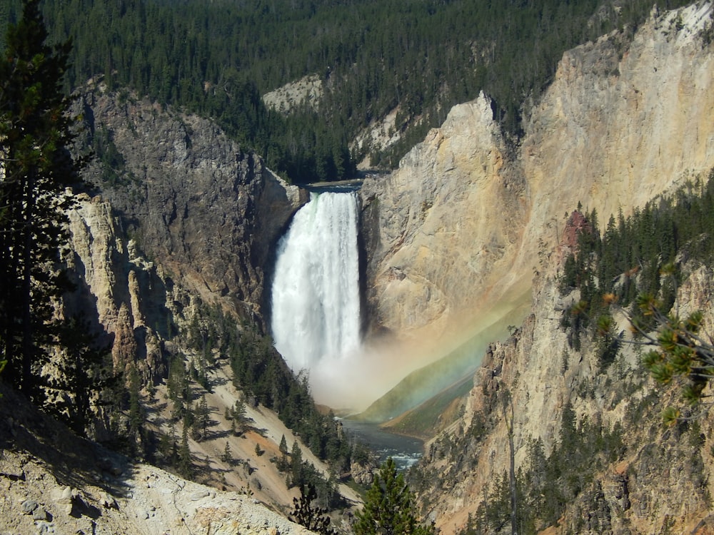 a waterfall with a rainbow in the middle of it