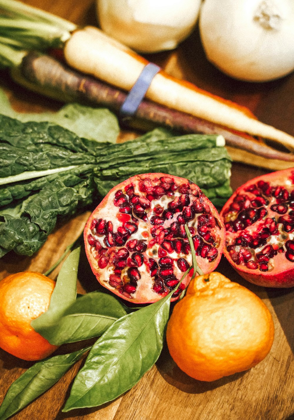 a cutting board topped with oranges and spinach