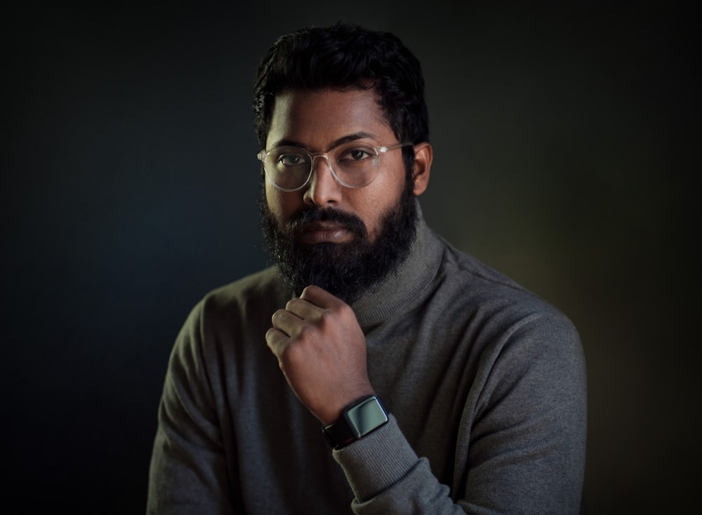 a man with a beard and glasses posing for a picture