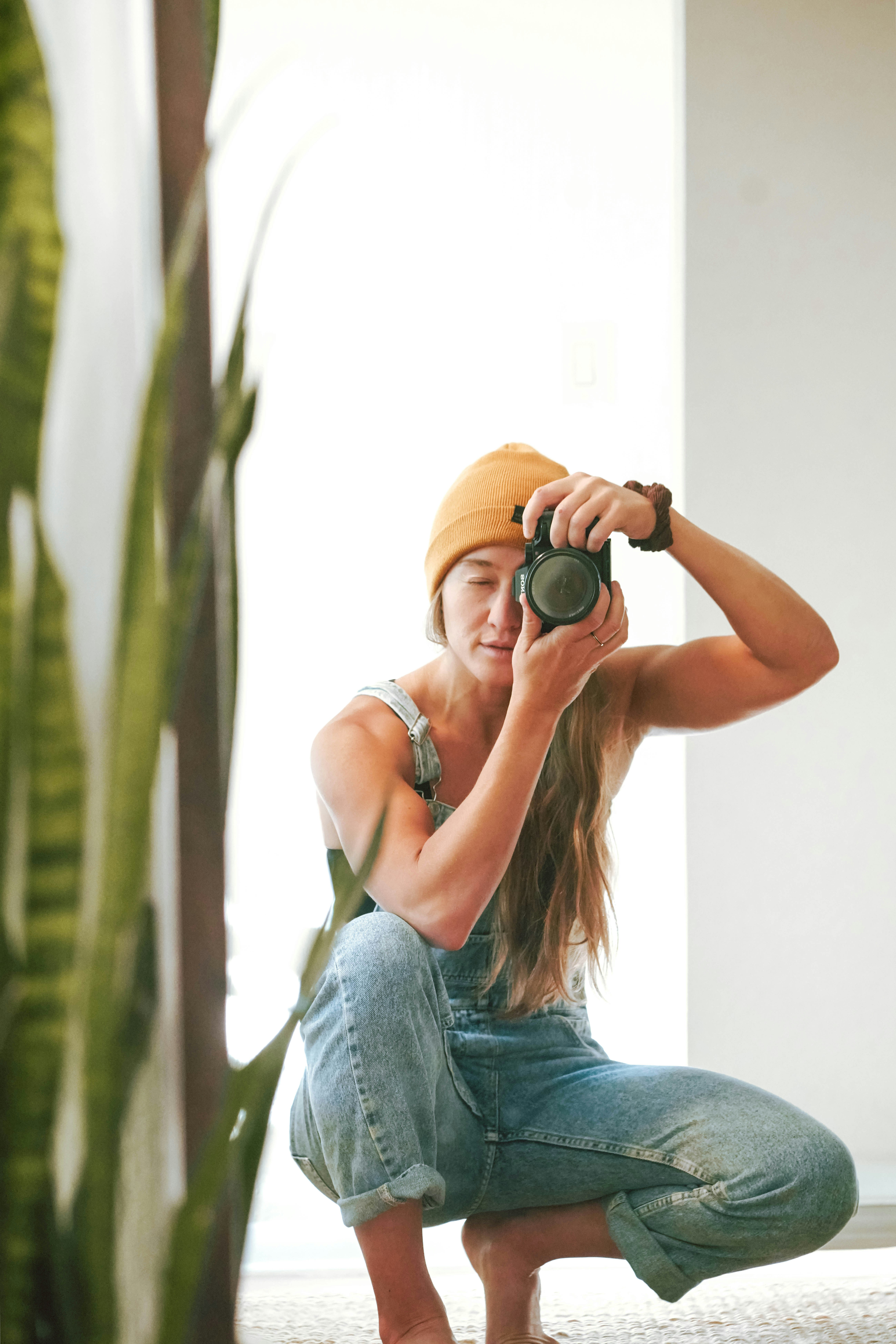 a woman squatting on the floor with a camera
