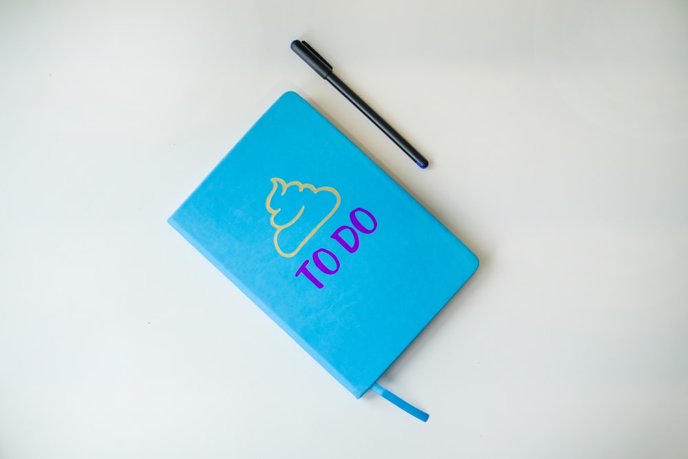 a notebook with a pen on top of it