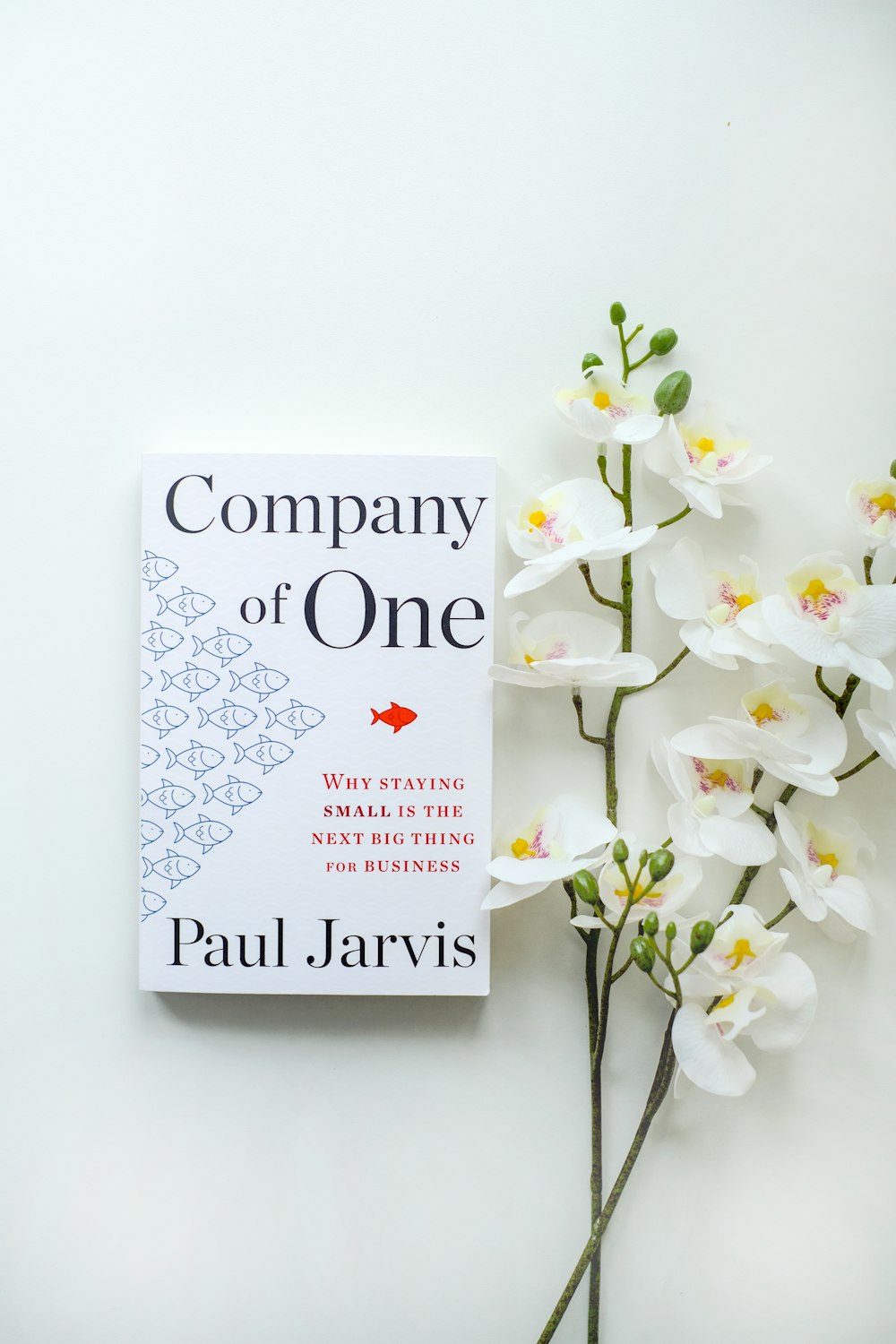 a book sitting on top of a table next to flowers