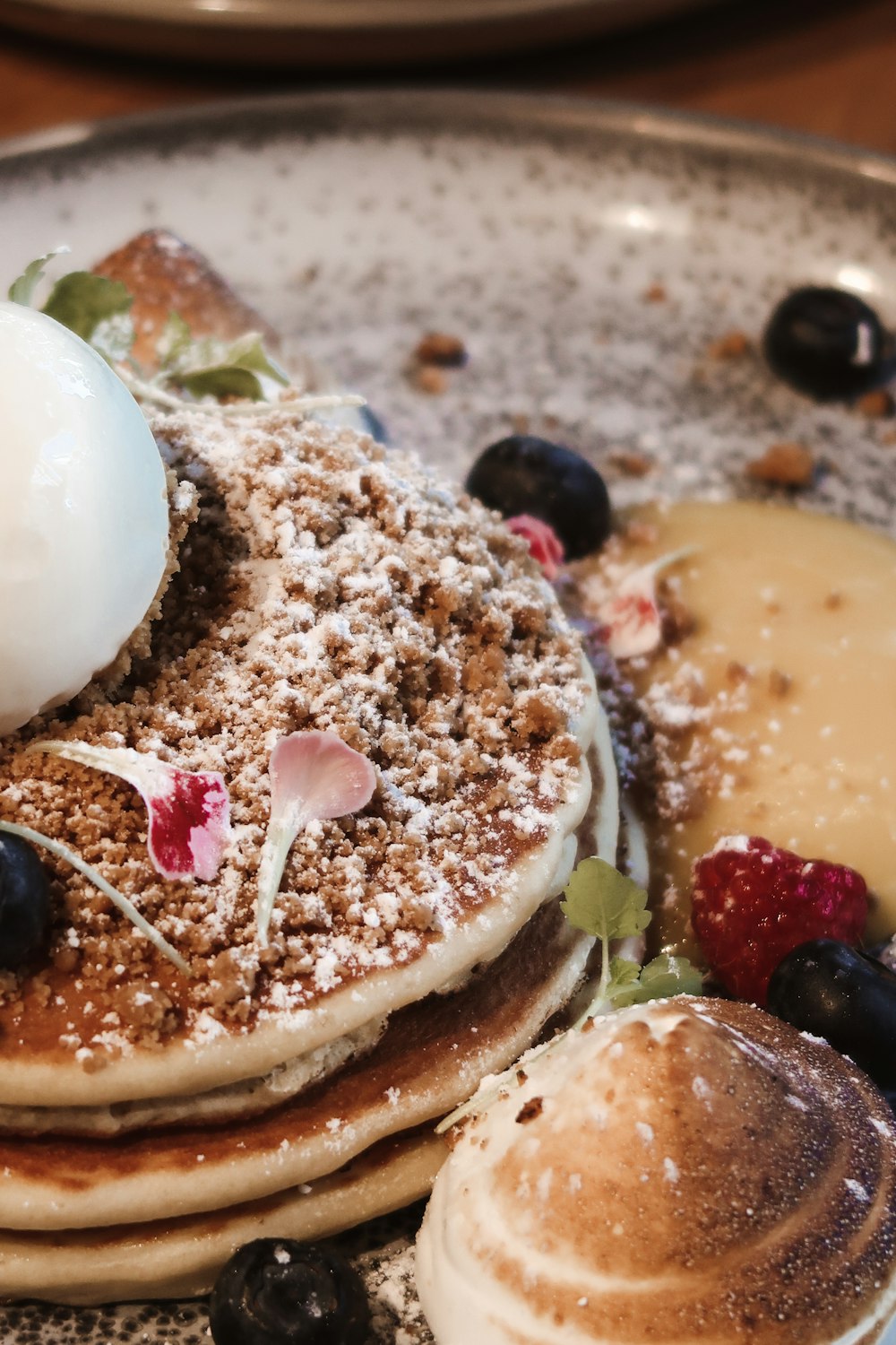 a plate topped with pancakes covered in powdered sugar