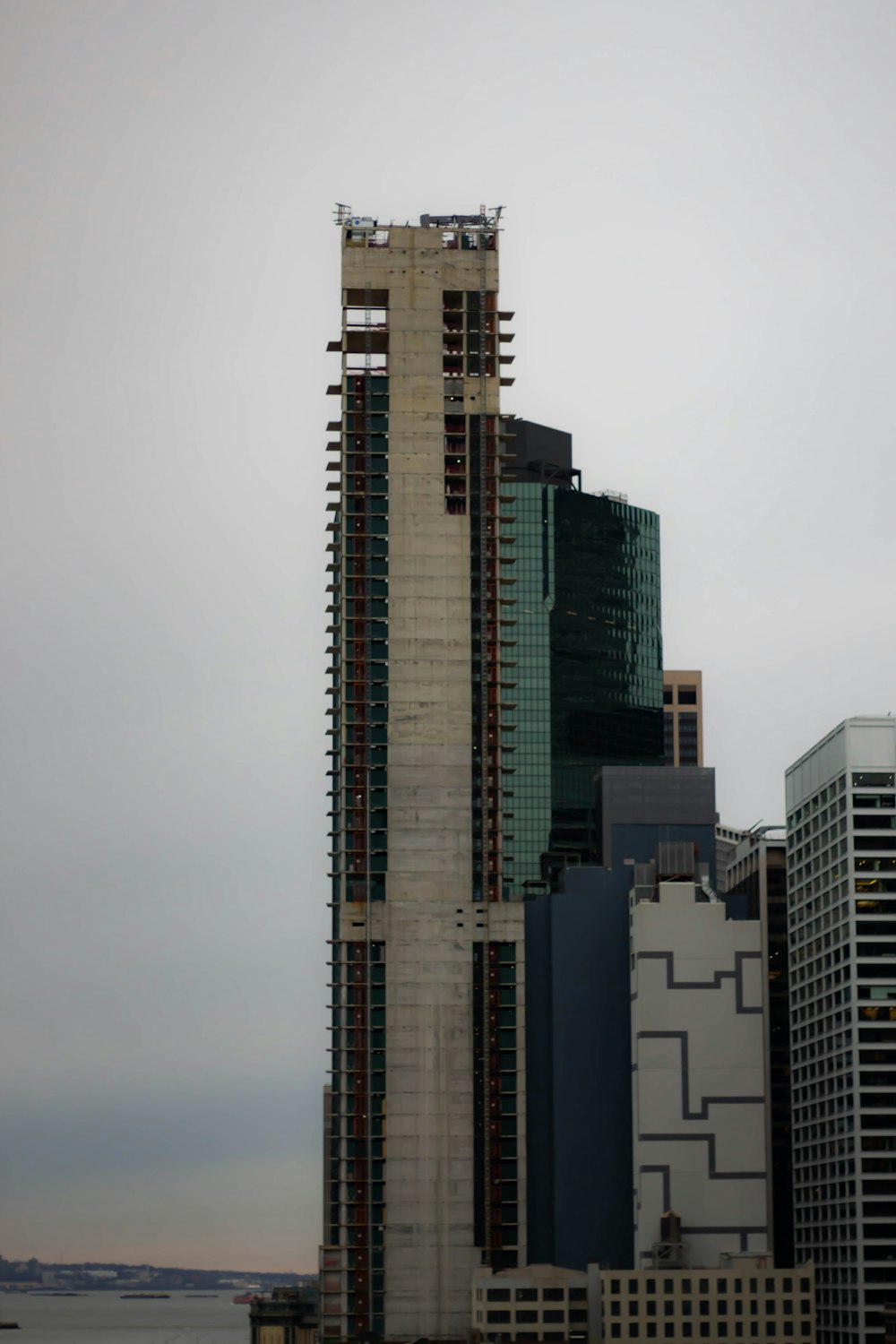 a tall building with a lot of windows next to a body of water