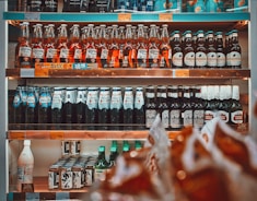 a shelf filled with lots of bottles of alcohol
