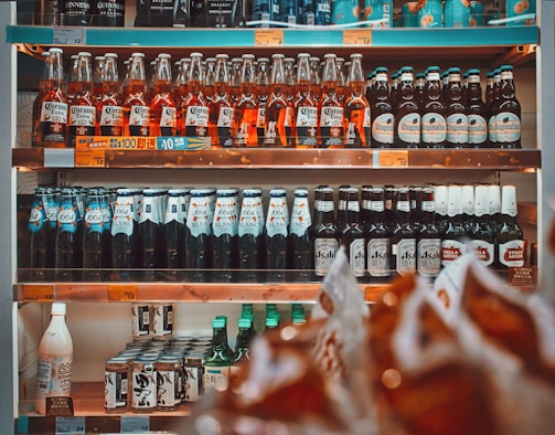a shelf filled with lots of bottles of alcohol