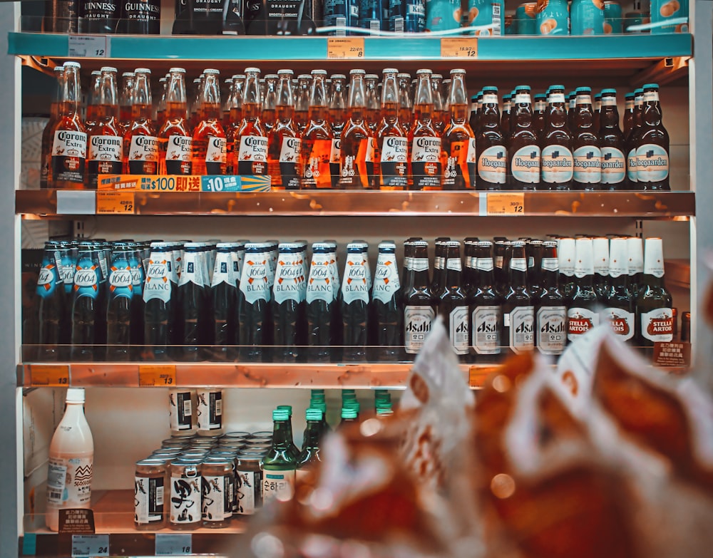 a shelf filled with lots of bottles of alcohol