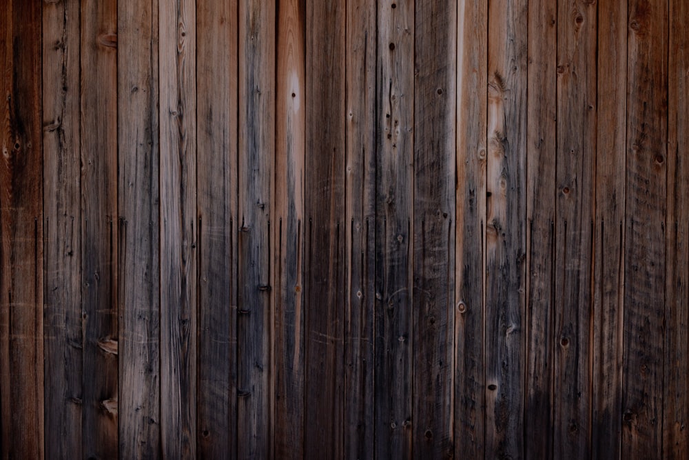 a close up of a wooden wall with a clock on it