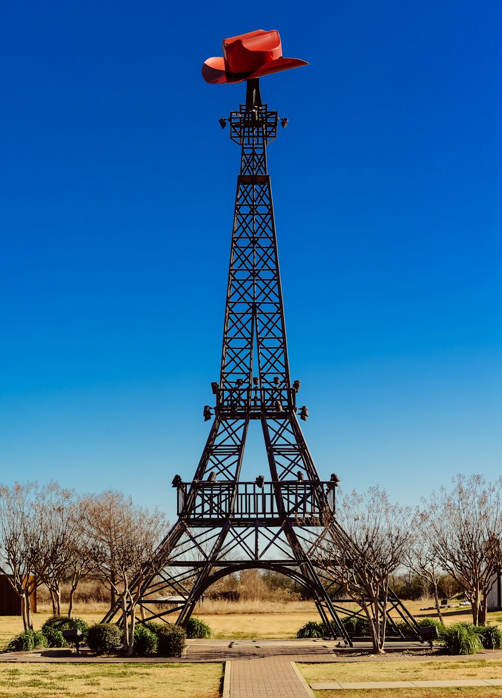 a very tall metal tower with a red roof