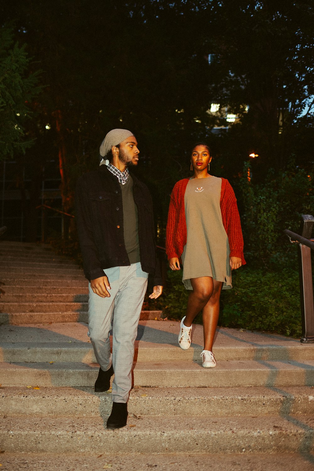 a man and a woman walking down a flight of stairs