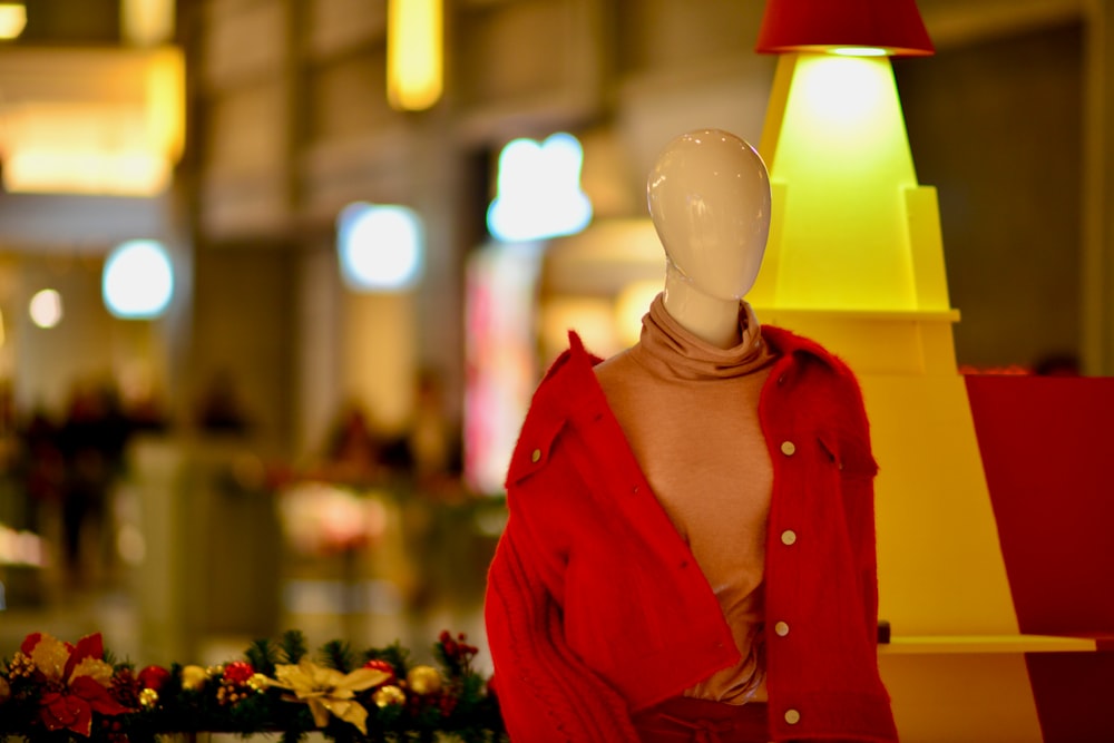 a mannequin wearing a red shirt and a red scarf