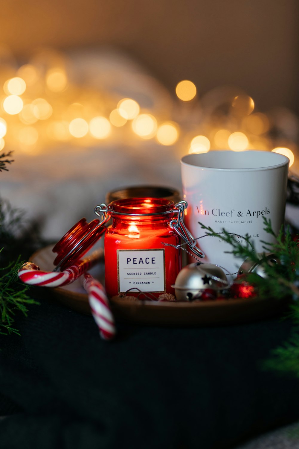 a candle and some candy canes on a tray