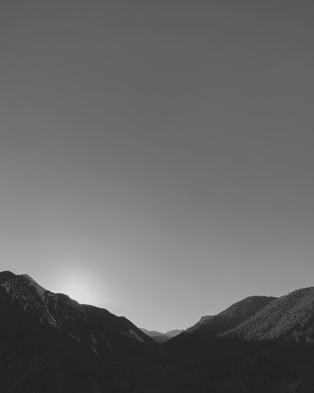 a black and white photo of a mountain range