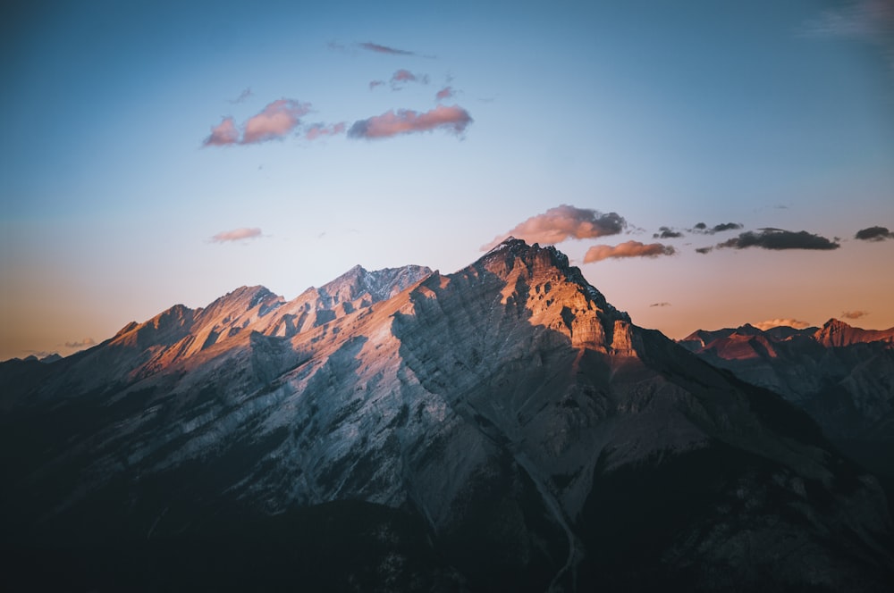 a view of the top of a mountain at sunset