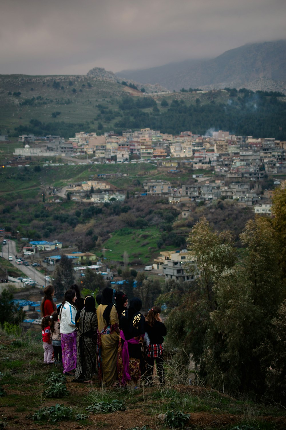 a group of people standing on top of a hill