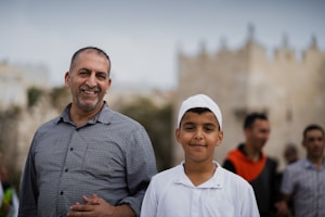 a man standing next to a young boy