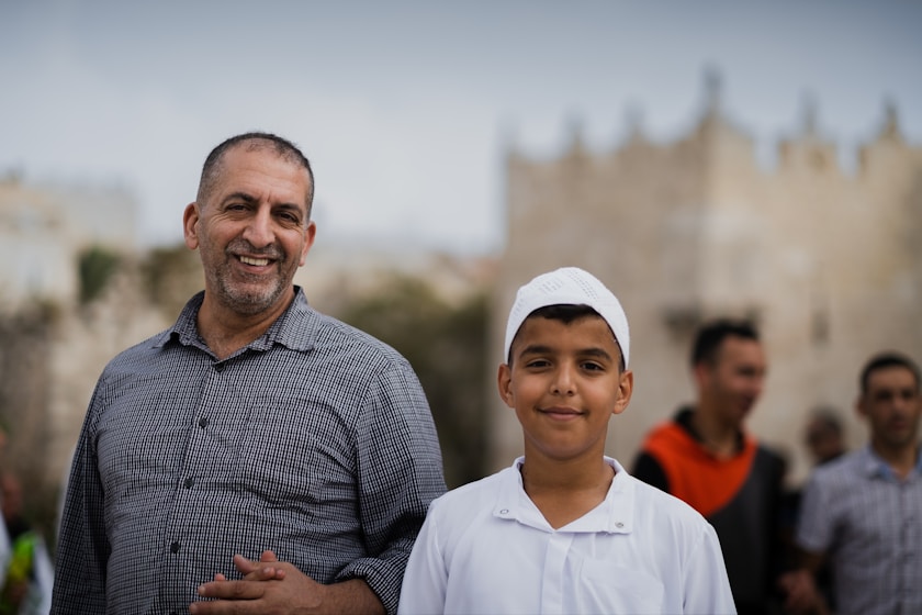 a man standing next to a young boy