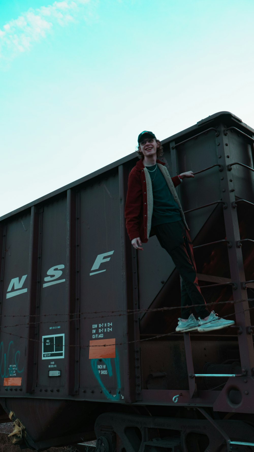 a man standing on top of a train car