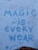 A brick wall with a graffiti-style message painted in blue, reading 'Magic is Everywhere' with playful symbols like dots and small stars accenting the letters.