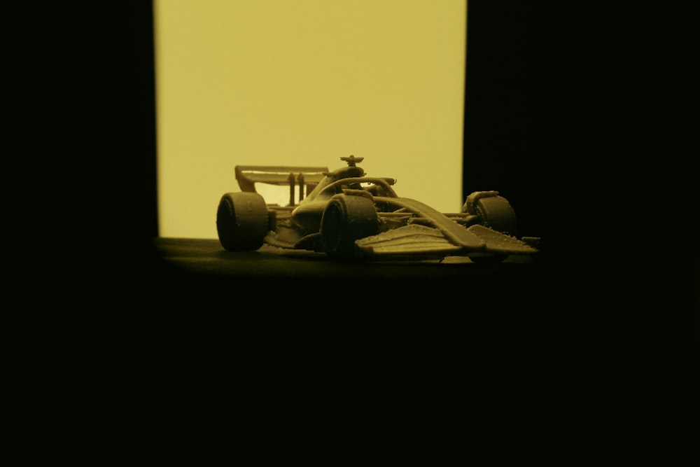 a model of a racing car in a dark room