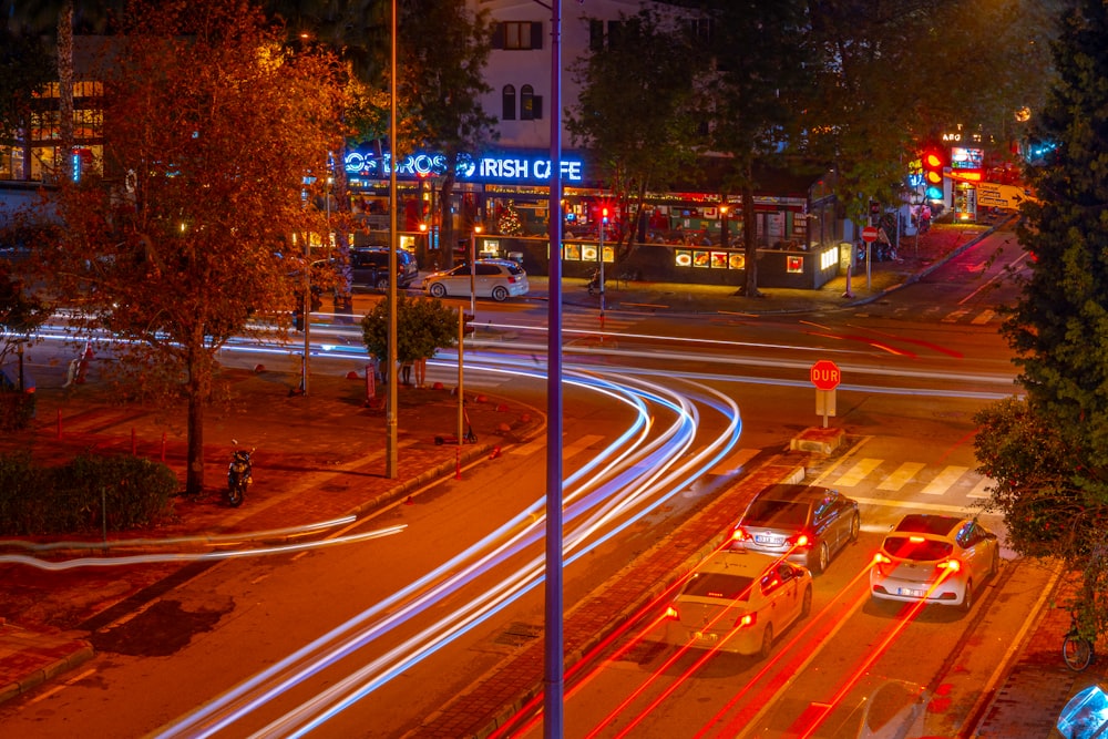 a busy city street at night with traffic lights