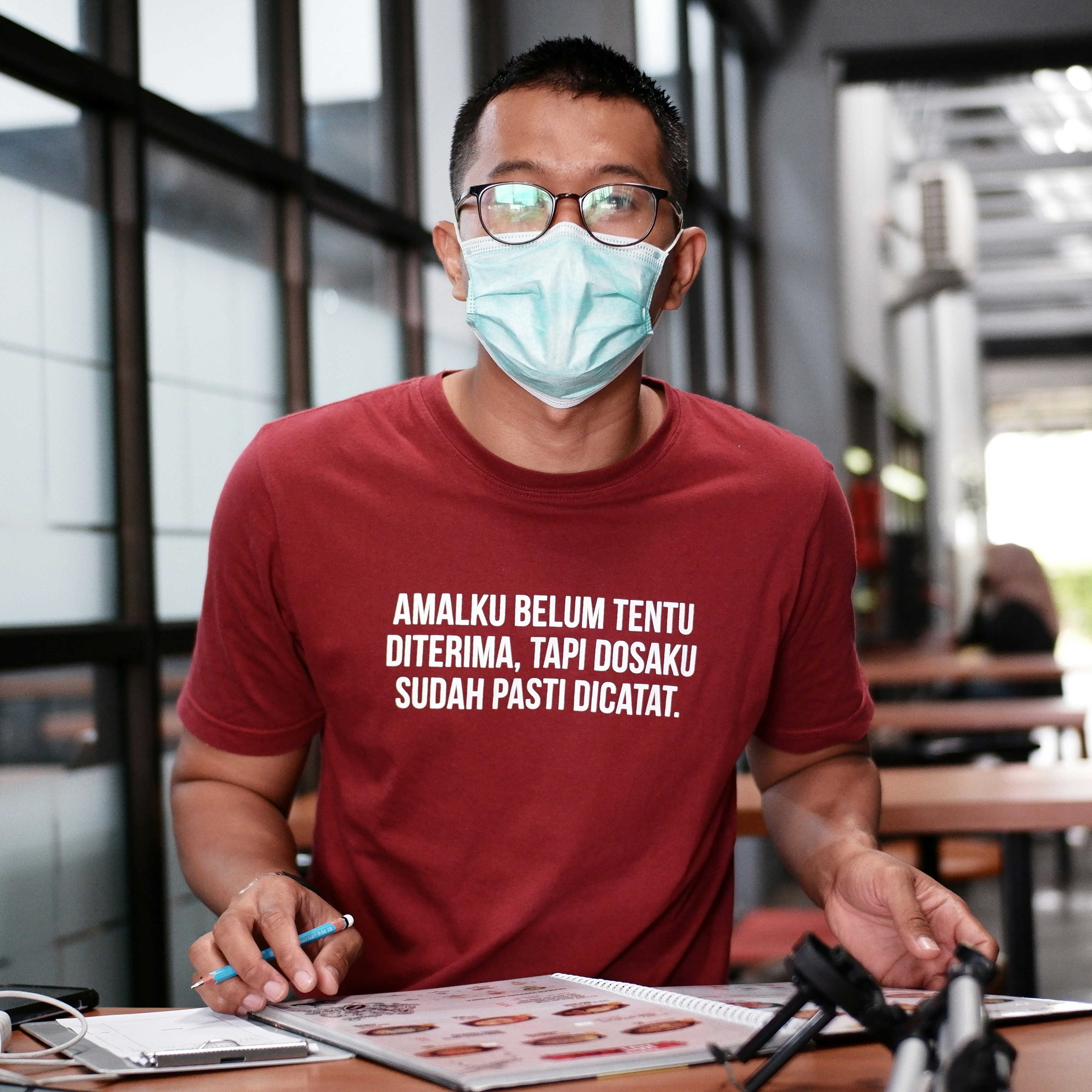 a man in a red shirt wearing a face mask