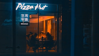a group of people sitting at a table outside of a restaurant