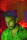 Side profile of a thoughtful man wearing headphones, lit by cool blue neon lights, with trading charts behind him