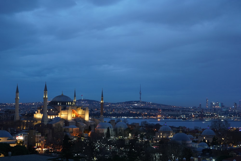 a view of a city at night from a hill