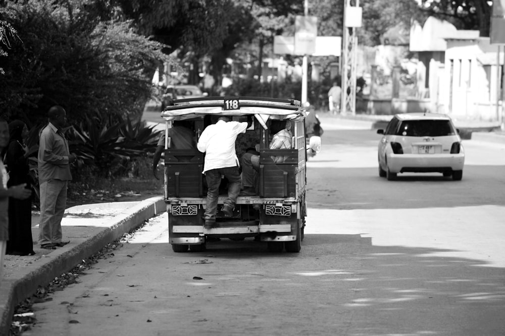 a black and white photo of a man in the back of a van