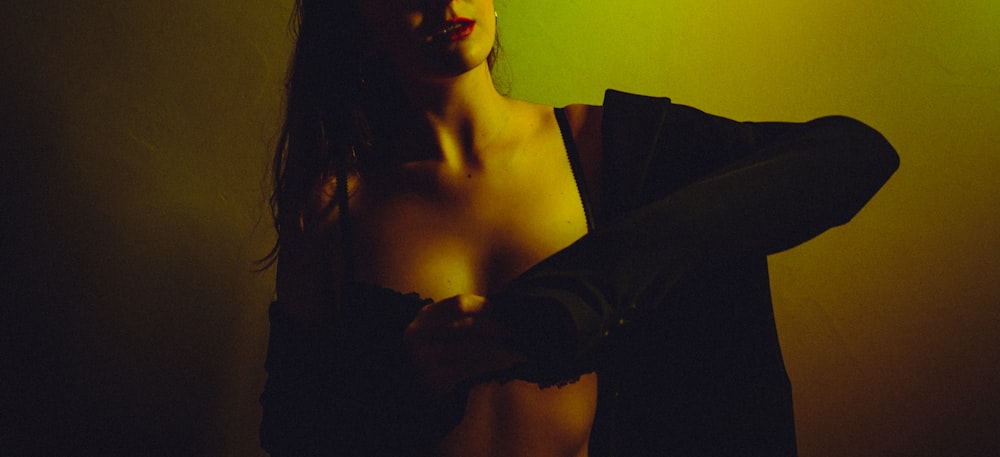 a woman in a dark room with a green light
