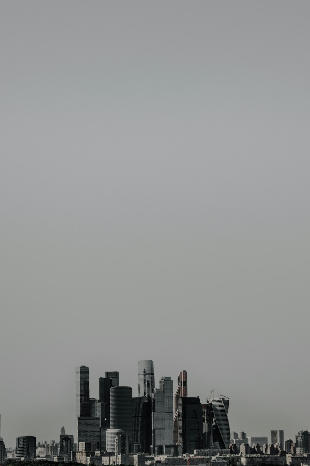 an airplane flying over a city with tall buildings