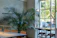 A cozy Scandinavian-style restaurant corner with warm lighting and fresh herbs on the windowsill.