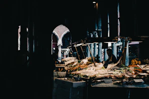 A photographer capturing a modern food market stall with vibrant displays under natural light.