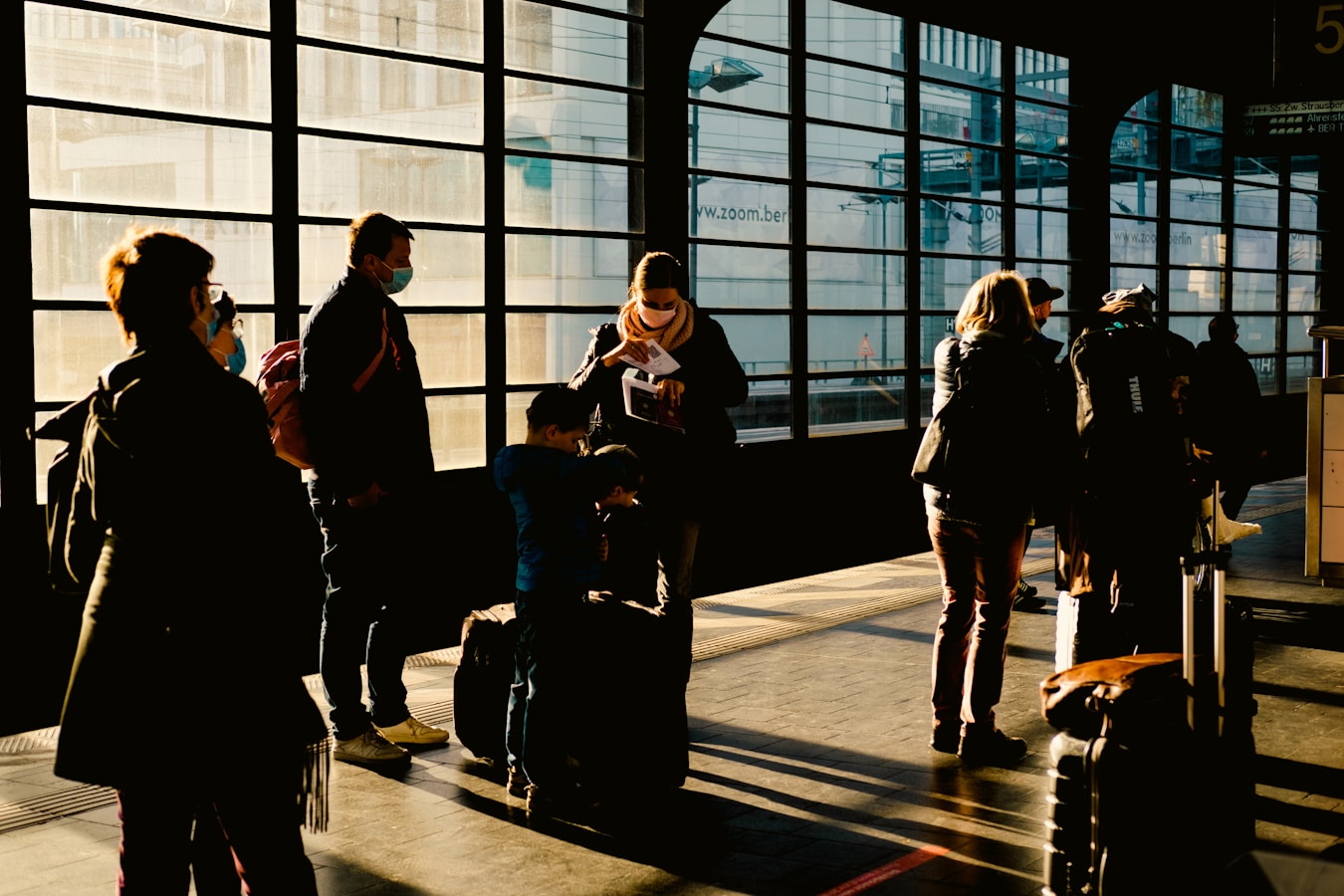 a group of people standing next to each other with luggage