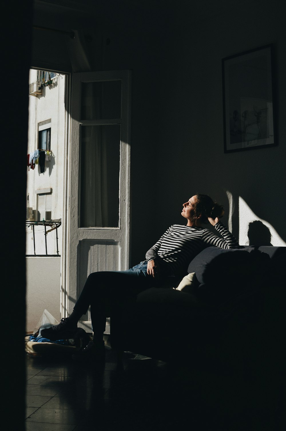 a man sitting on a couch in a dark room