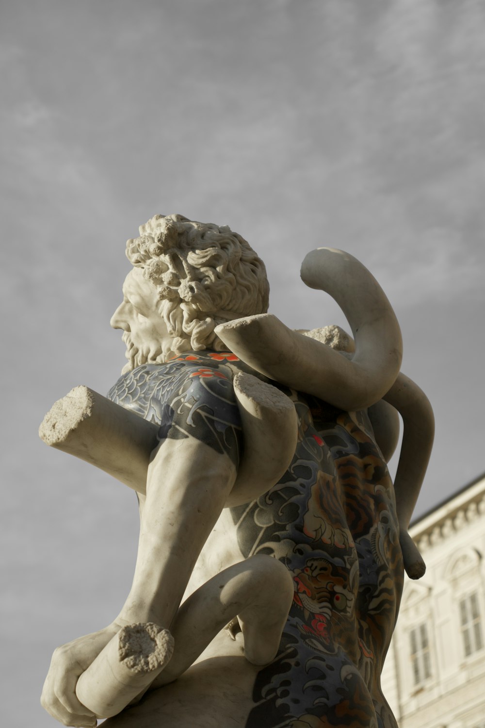 a statue of a man holding an elephant