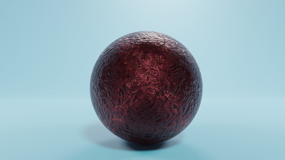 a red egg sitting on top of a blue surface