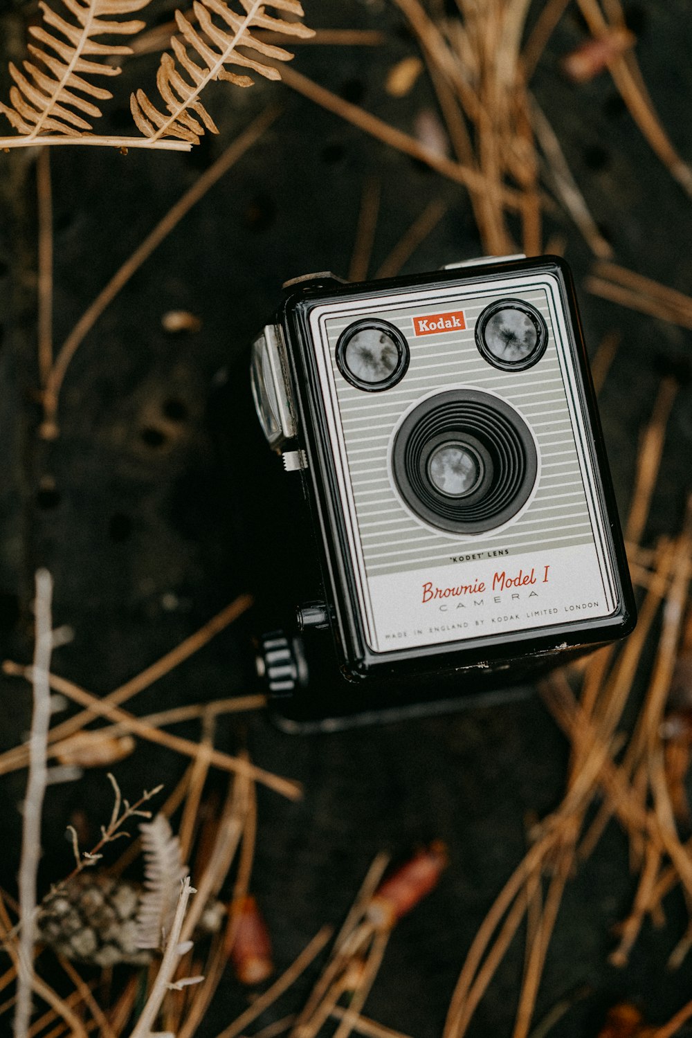 an old camera sitting in the middle of a field