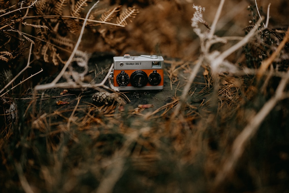 an old camera sitting in the middle of a field