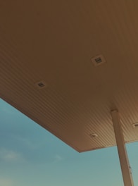 Construction crew working on fuel station canopy installation.